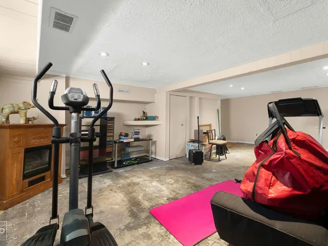a living room with furniture a rug and white walls
