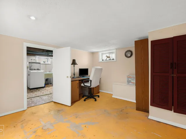 a view of a livingroom with workspace and a window