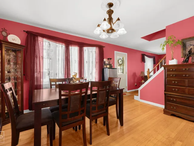 a view of a dining room with furniture and chandelier