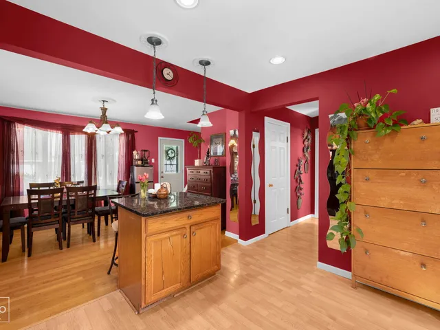 a kitchen with stainless steel appliances kitchen island granite countertop a stove a refrigerator and cabinets