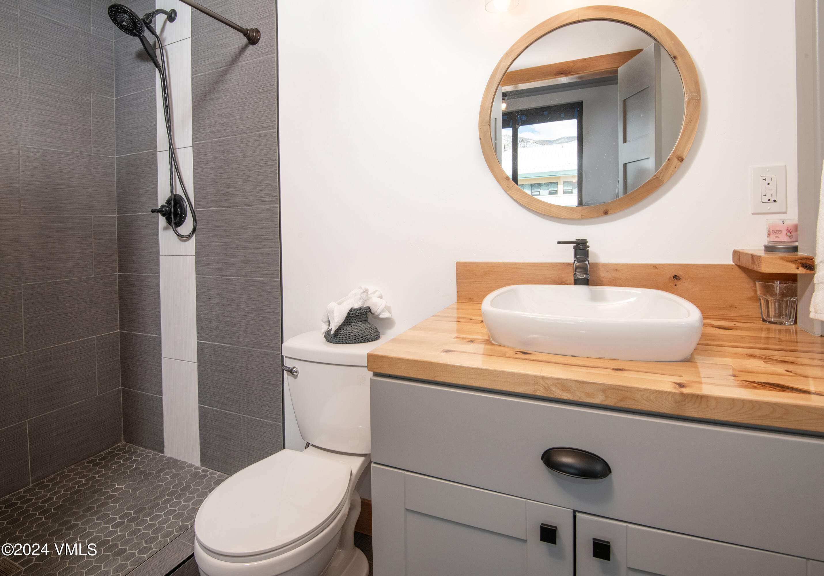 70 Benchmark Road, Unit 201 Avon, CO 81620 - Photo 12 of 32 a bathroom with a toilet a sink and mirror