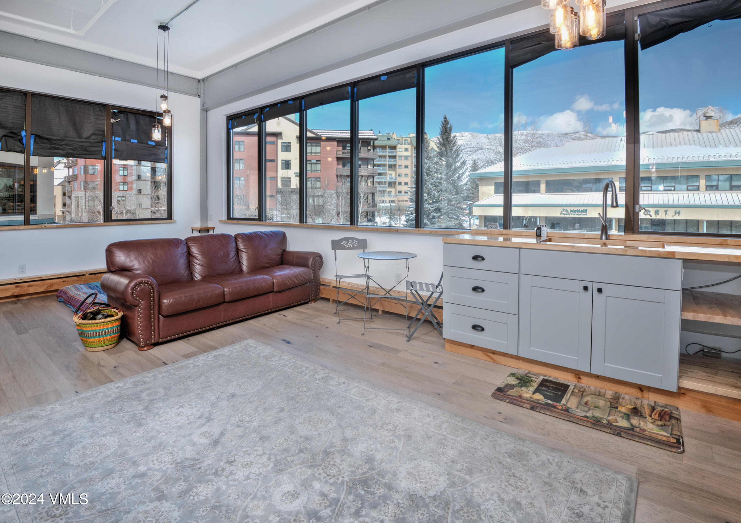 70 Benchmark Road, Unit 201 Avon, CO 81620 - Photo 2 of 32 a living room with furniture and large windows