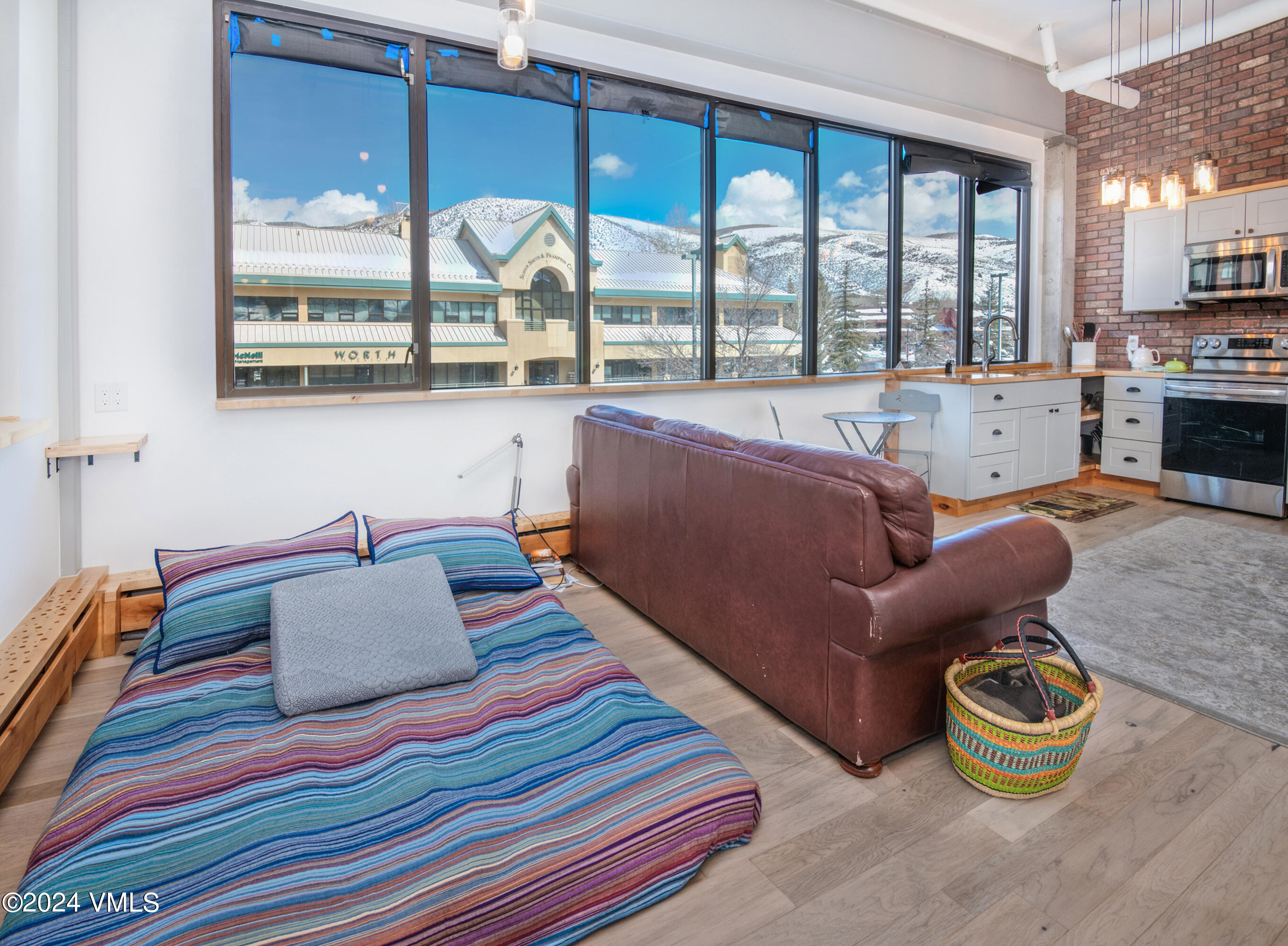 70 Benchmark Road, Unit 201 Avon, CO 81620 - Photo 10 of 32 a bedroom with furniture and a large window