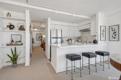 a kitchen with refrigerator and cabinets