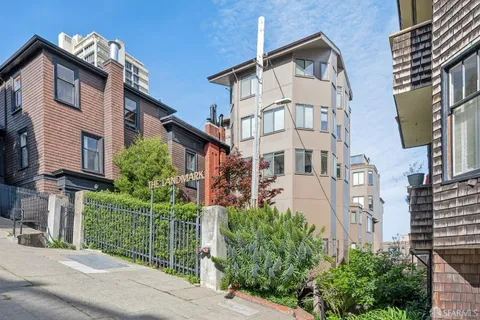 a front view of a multi story building with yard