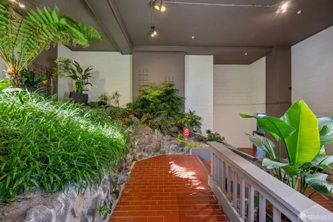 a living room with furniture and a potted plant