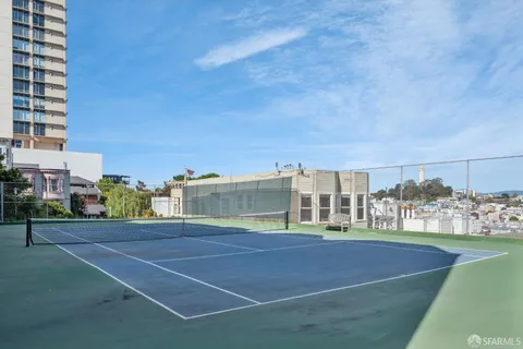 a view of a balcony with wooden furniture