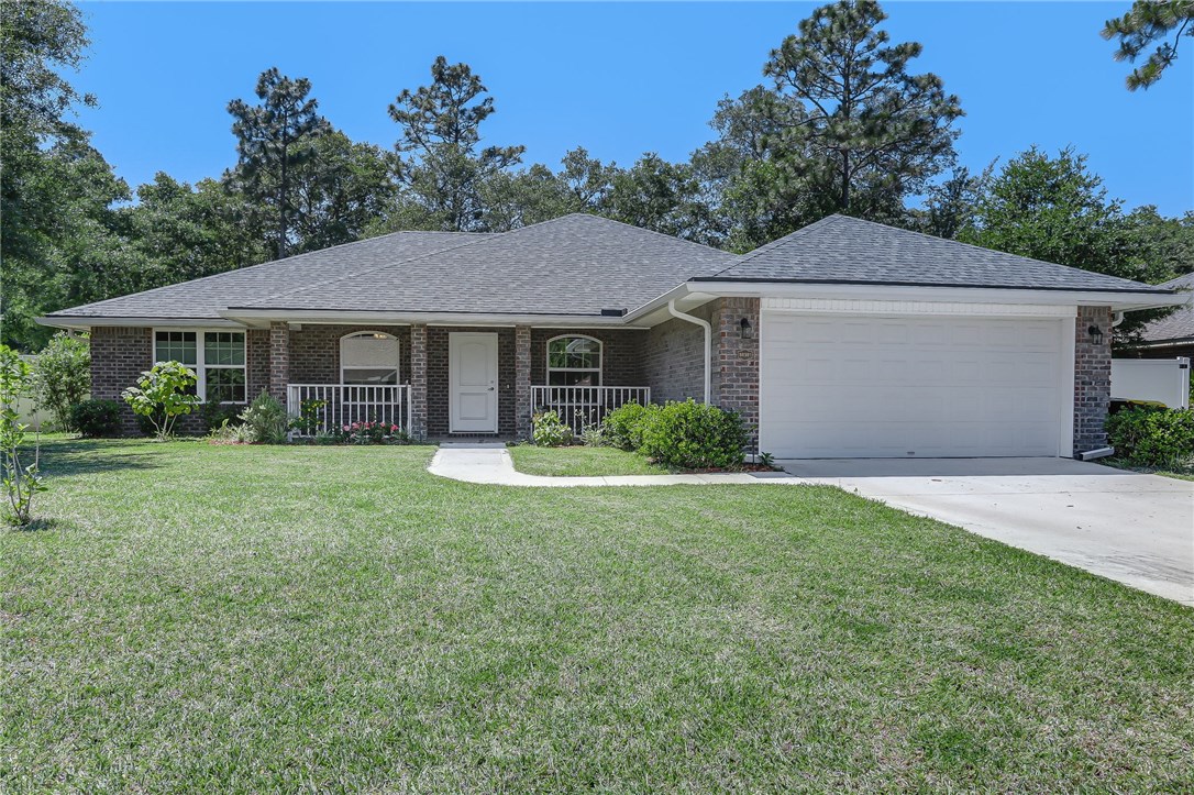 a front view of a house with a garden