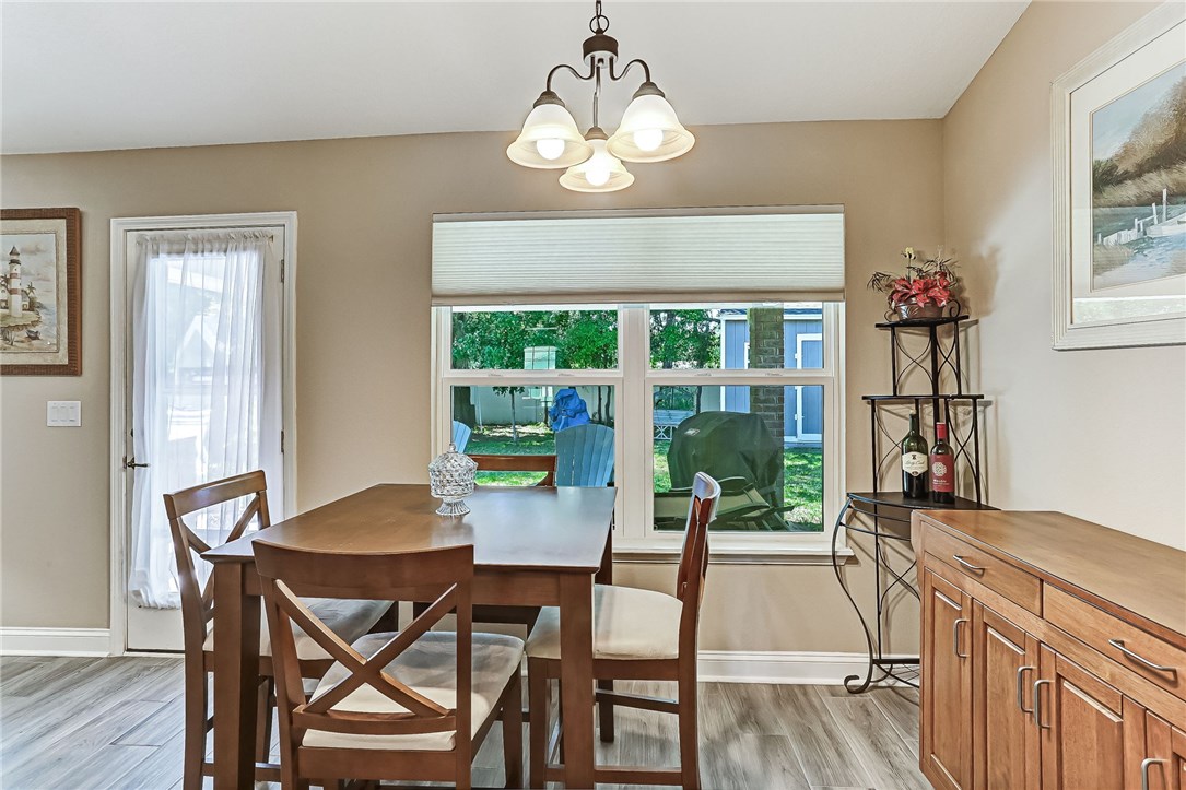 88381 Maybourne Road Yulee, FL 32097 - Photo 12 of 24 a view of a dining room with furniture window and wooden floor