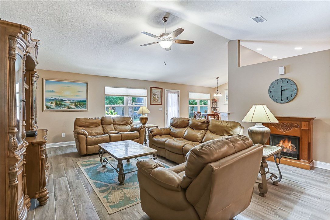 88381 Maybourne Road Yulee, FL 32097 - Photo 15 of 24 a living room with furniture a fireplace and a window