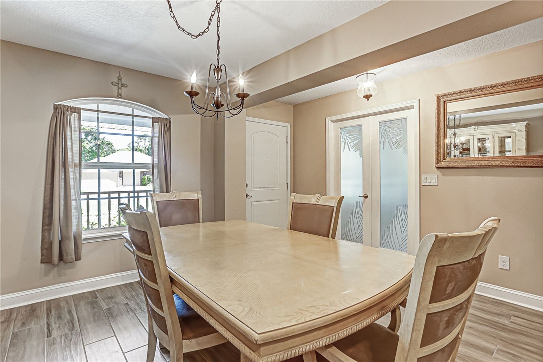 88381 Maybourne Road Yulee, FL 32097 - Photo 19 of 24 a view of a dining room with furniture window and wooden floor