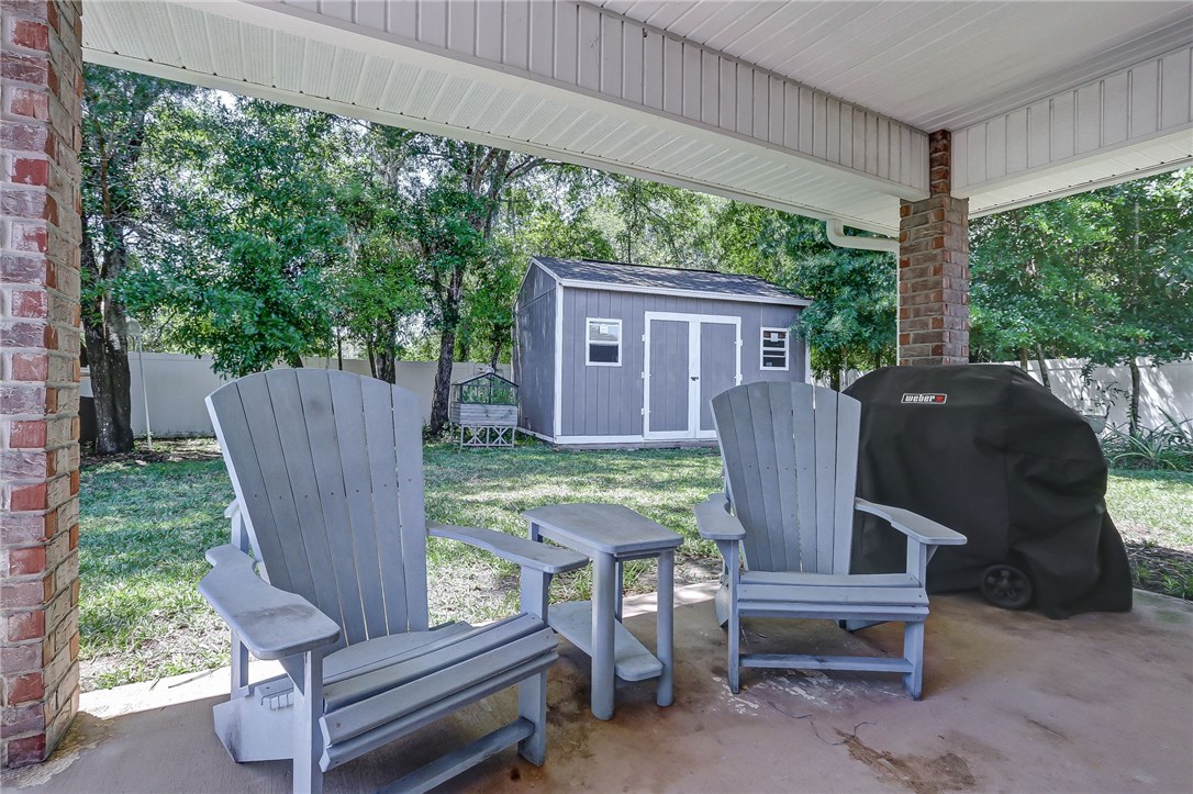 88381 Maybourne Road Yulee, FL 32097 - Photo 23 of 24 a view of a wooden bench in back yard of a house