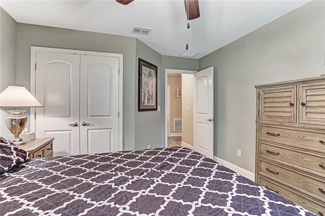88381 Maybourne Road Yulee, FL 32097 - Photo 4 of 24 a bedroom with a bed and a lamp
