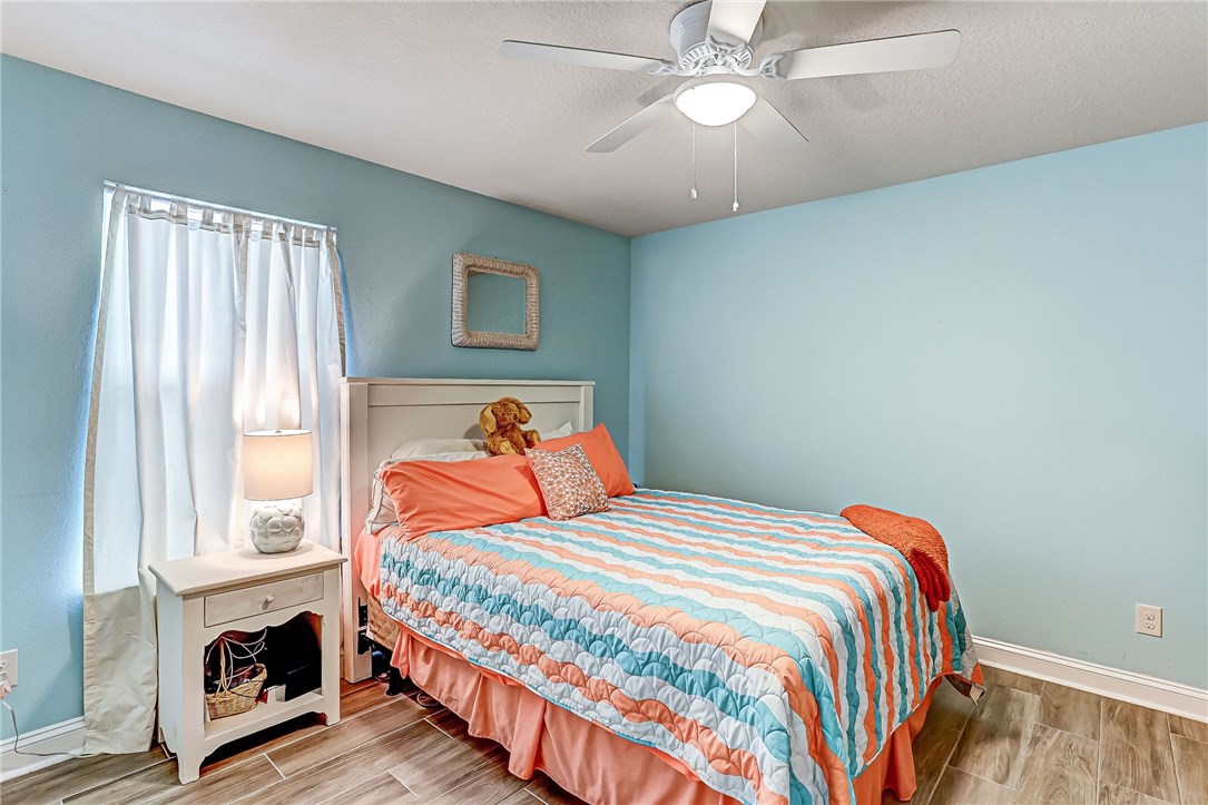 88381 Maybourne Road Yulee, FL 32097 - Photo 5 of 24 a bedroom with a bed and a fireplace