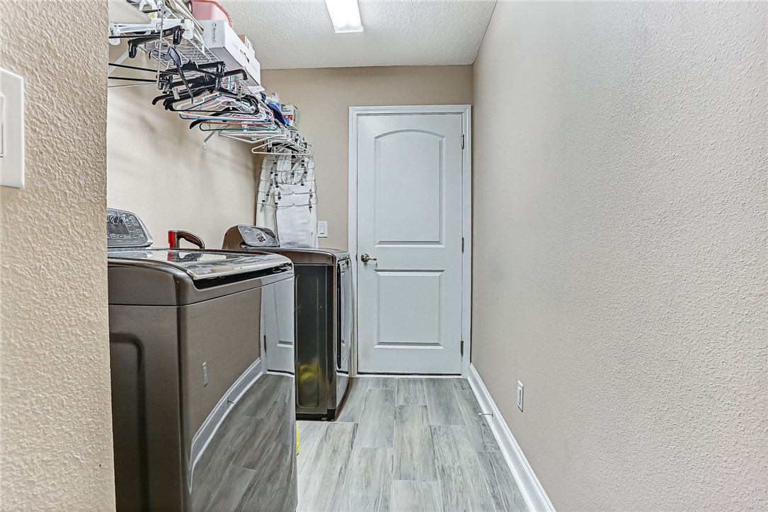 88381 Maybourne Road Yulee, FL 32097 - Photo 6 of 24 a utility room with a sink dryer and washer