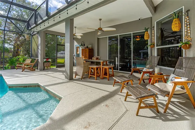 a view of a livingroom with furniture hardwood floor and a large window