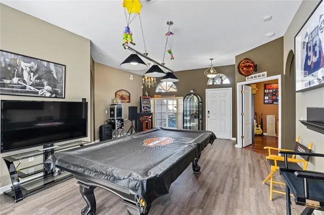a kitchen with a sink a counter top space stainless steel appliances and cabinets