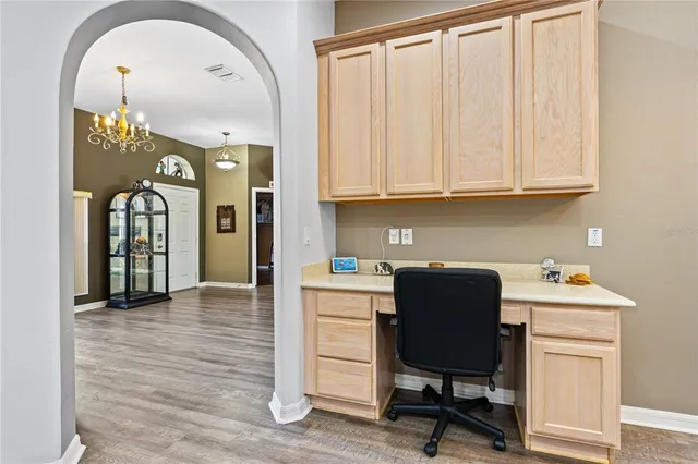 a kitchen with stainless steel appliances granite countertop a refrigerator a sink dishwasher a stove top oven a refrigerator with island and cabinets