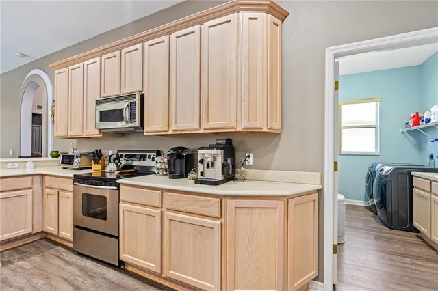 a view of a kitchen with sink microwave and stove