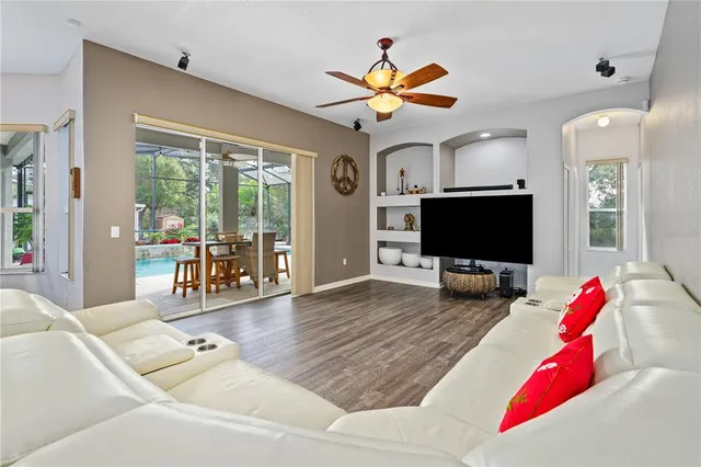 a living room with kitchen island furniture and a chandelier