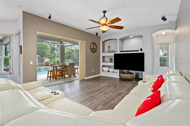 a view of a hallway with wooden floor and furniture