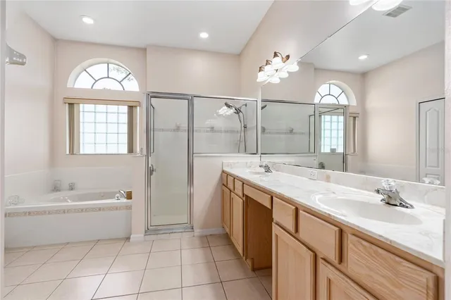 a spacious bathroom with a double vanity sink mirror and double