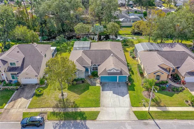an aerial view of residential houses with outdoor space and swimming pool