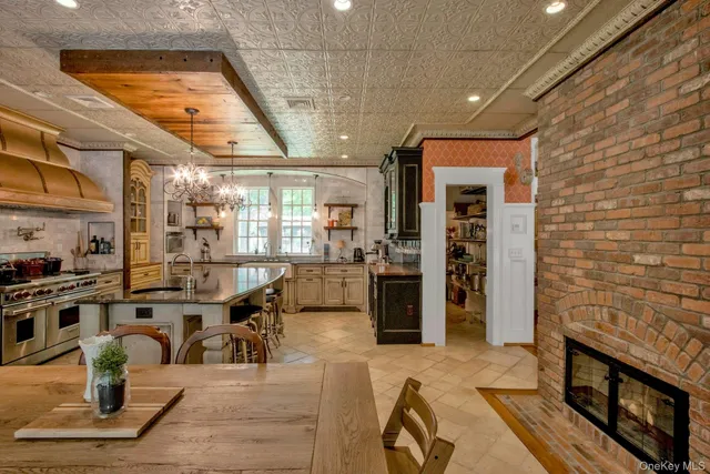 a living room with couches a flat screen tv and kitchen view