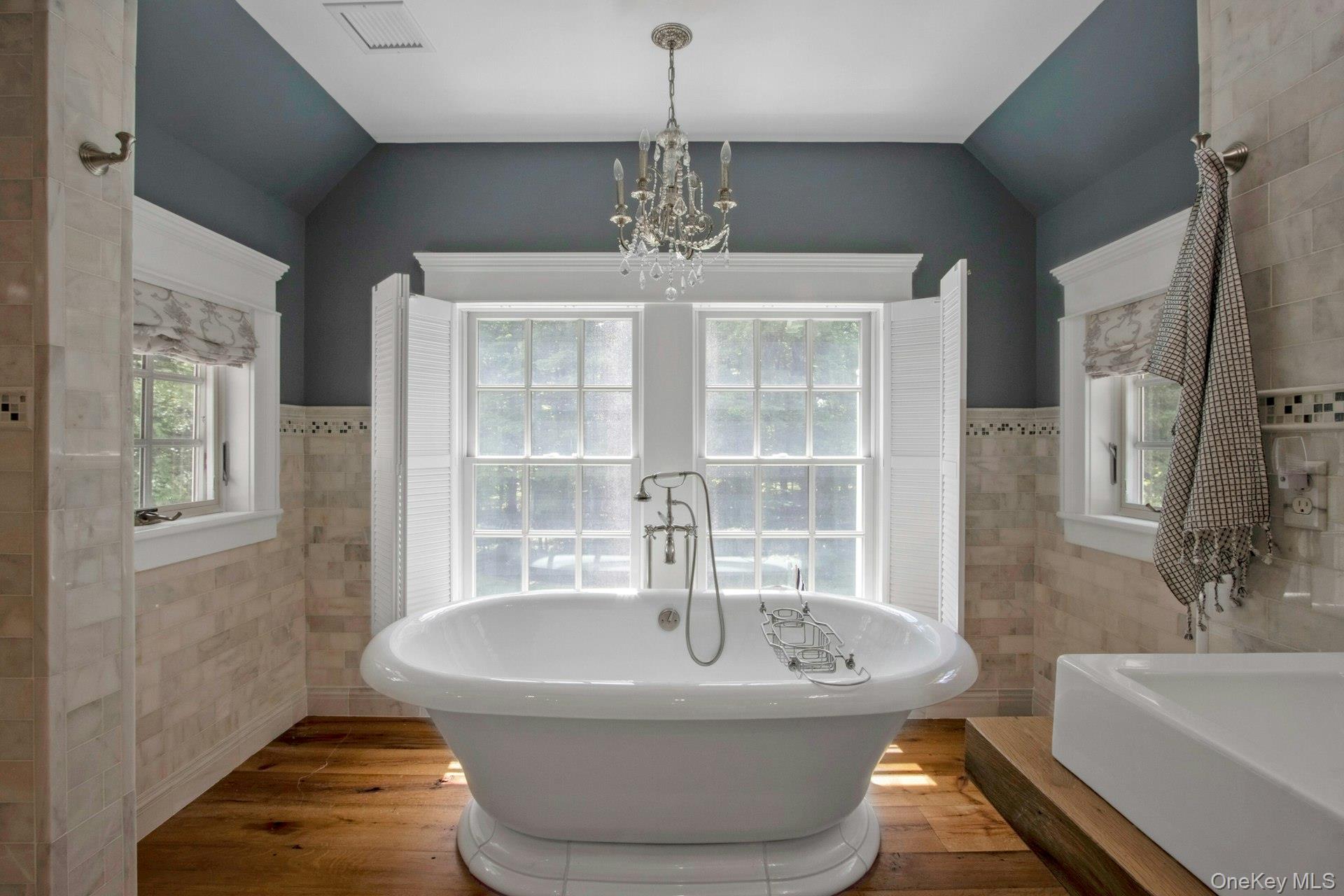 314 Haverstraw Road Suffern, NY 10901 - Photo 29 of 44 a spacious bathroom with a bathtub and chandelier