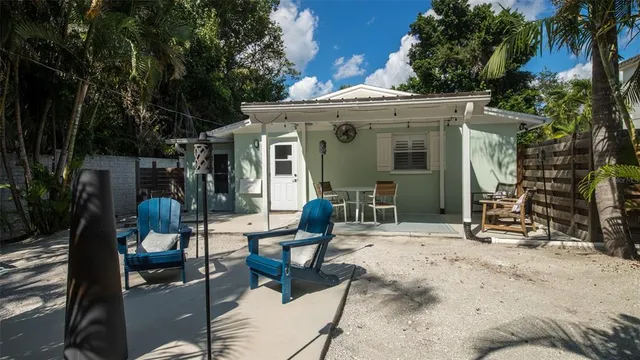 a view of a patio with table and chairs and potted plants