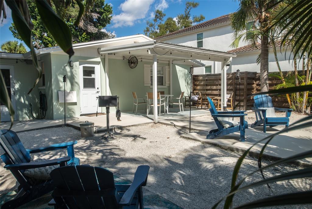 1805 Ivanhoe Street Sarasota, FL 34231 - Photo 14 of 34 a view of a patio with table and chairs and potted plants
