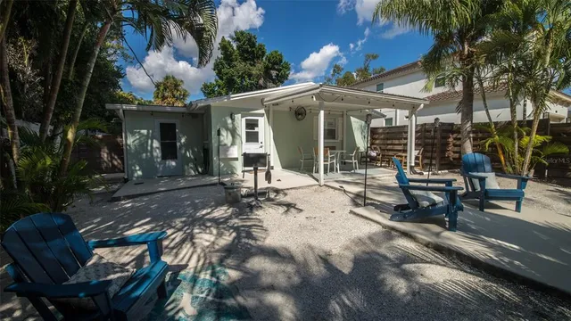 a view of a patio with table and chairs potted plants with wooden floor