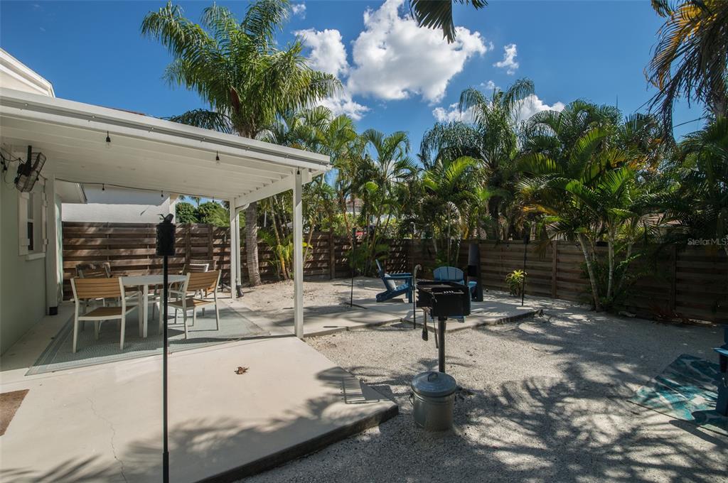1805 Ivanhoe Street Sarasota, FL 34231 - Photo 16 of 34 a view of a patio with table and chairs potted plants with wooden floor