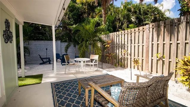a view of a chairs and table in backyard
