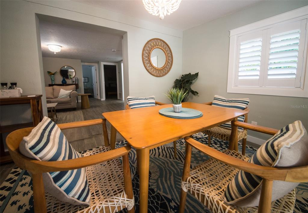 1805 Ivanhoe Street Sarasota, FL 34231 - Photo 34 of 34 a view of a dining room and livingroom with furniture wooden floor and a rug