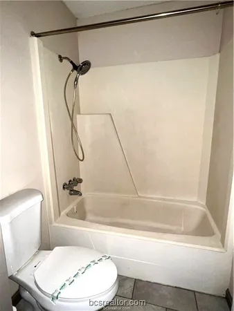 a bathroom with a toilet and a bathtub