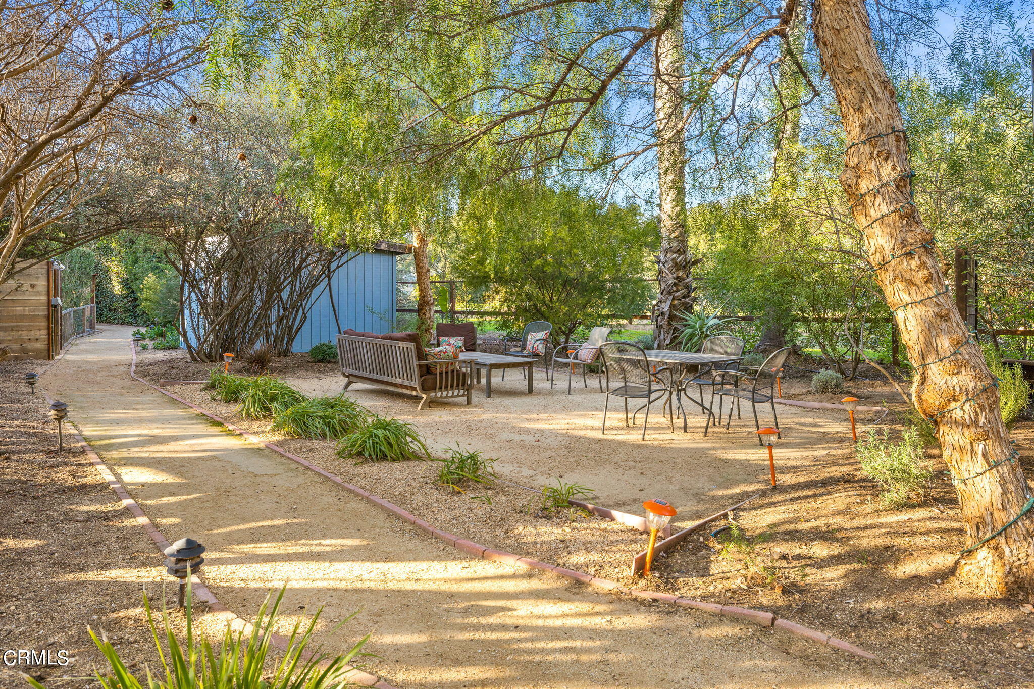 332 North Rice Road Ojai, CA 93023 - Photo 28 of 50 a view of a patio with table and chairs next to yard and a large tree