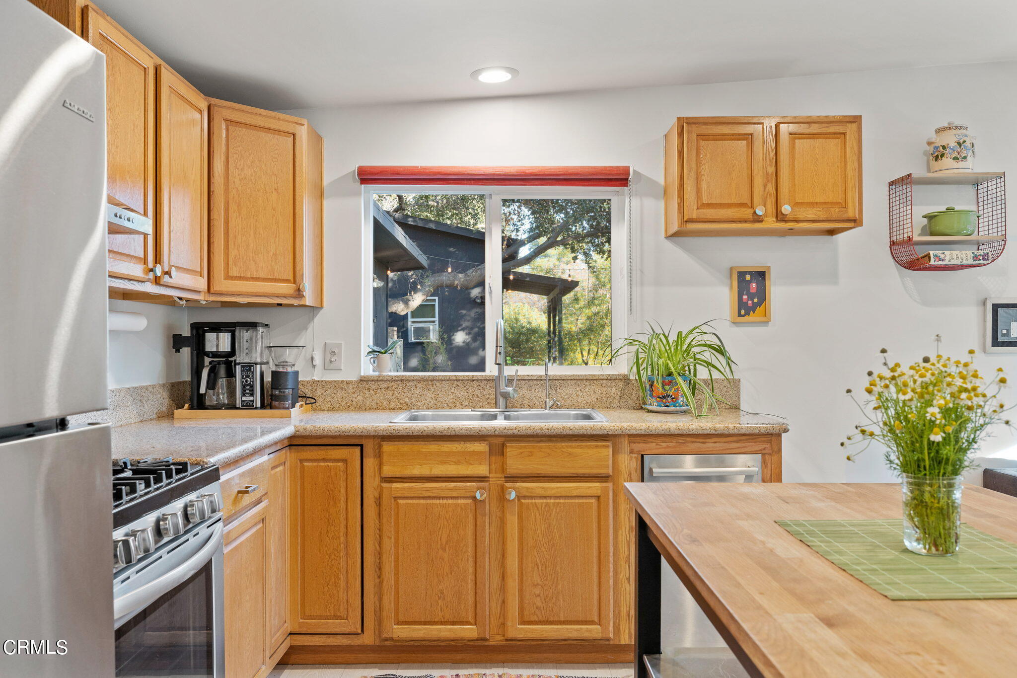 332 North Rice Road Ojai, CA 93023 - Photo 32 of 50 a kitchen with stainless steel appliances granite countertop a stove a sink and a microwave