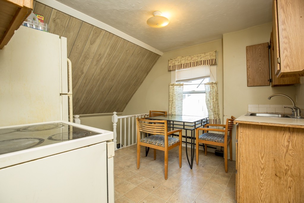 11 Phillips Avenue Lynn, MA 01902 - Photo 15 of 15 a kitchen with a table chairs and a sink