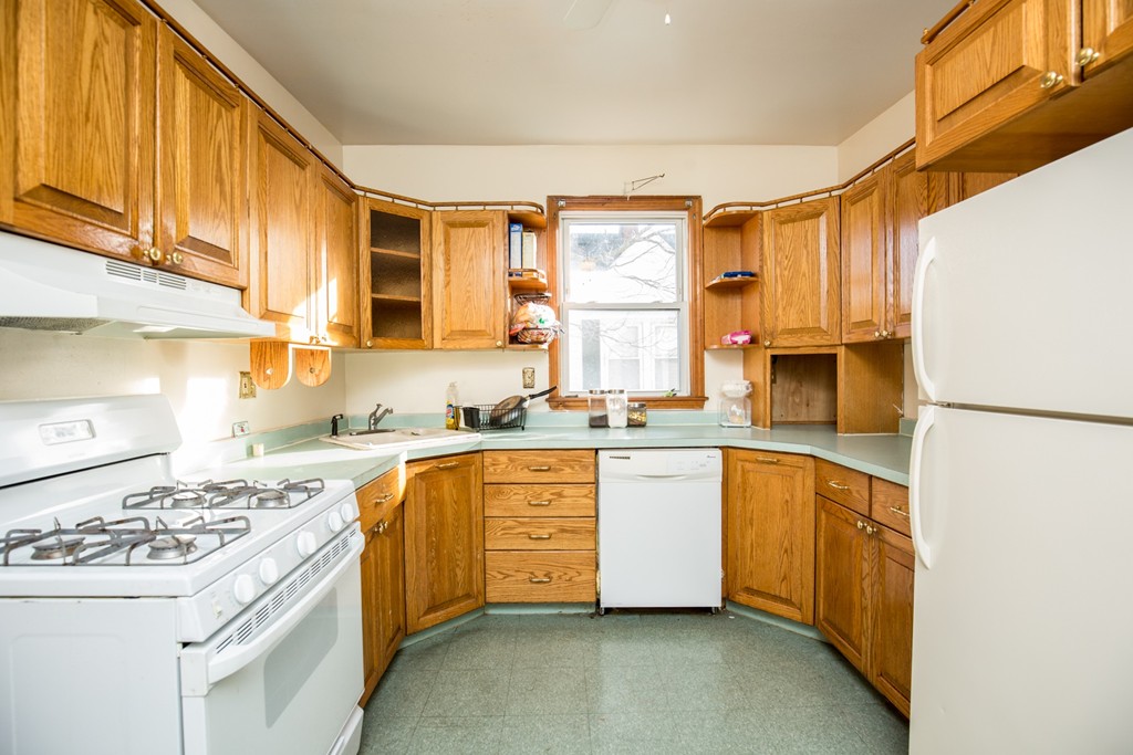 11 Phillips Avenue Lynn, MA 01902 - Photo 3 of 15 a kitchen with a sink stove and refrigerator