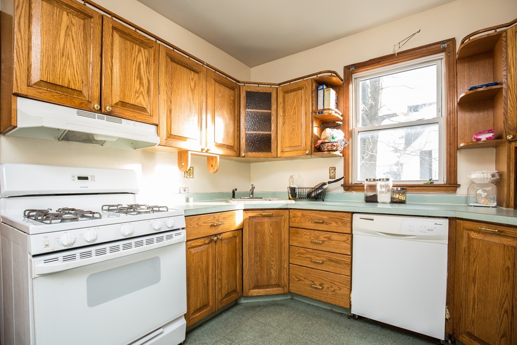11 Phillips Avenue Lynn, MA 01902 - Photo 4 of 15 a kitchen with cabinets appliances a sink and a window