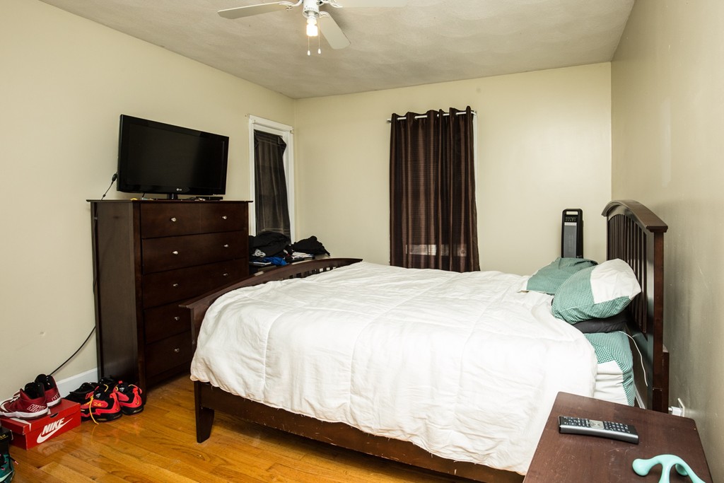 11 Phillips Avenue Lynn, MA 01902 - Photo 9 of 15 a bedroom with a bed and a flat screen tv