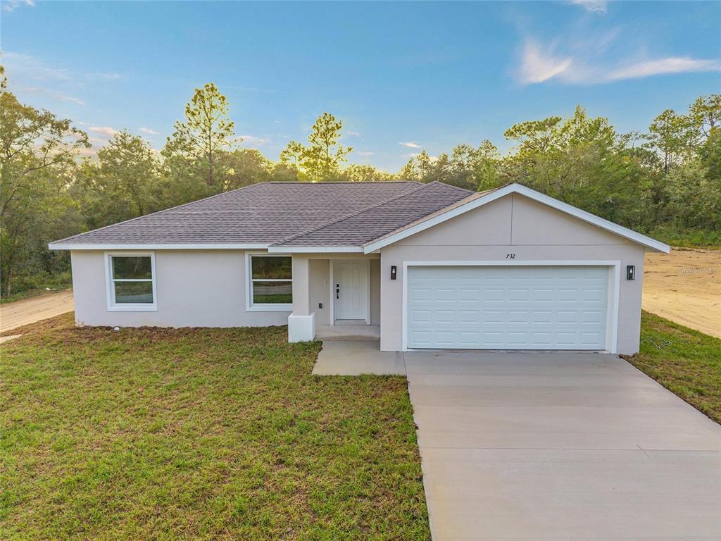 732 Southwest Fig Tree Lane Dunnellon, FL 34431 - Photo 1 of 1 a view of a house with a yard and potted plants