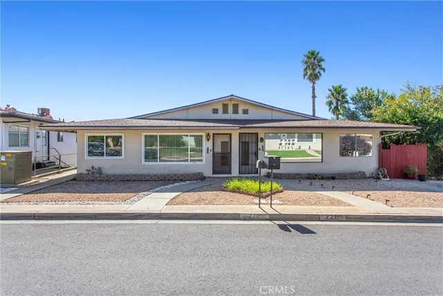 a front view of a house with a garden and patio
