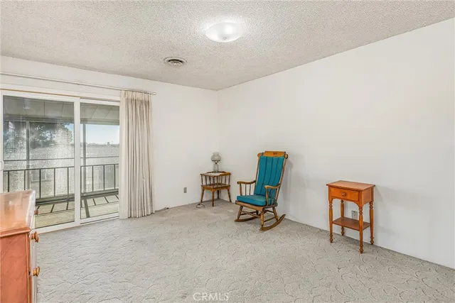 a view of a room with furniture and a window