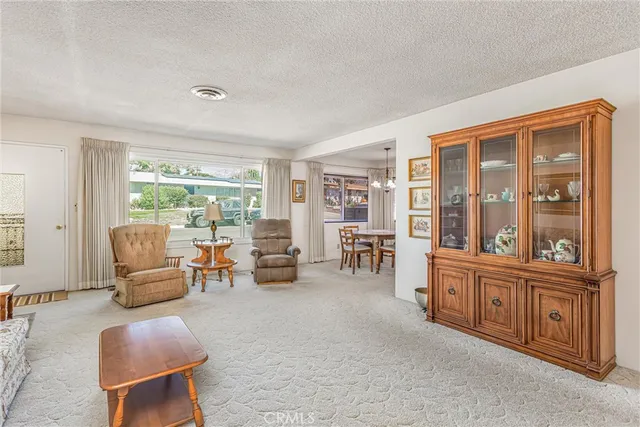 a living room with furniture and large windows