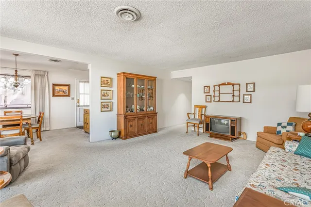 a living room with furniture and a gym machine
