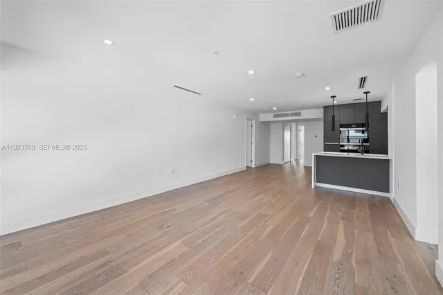a view of a kitchen with a sink and a refrigerator