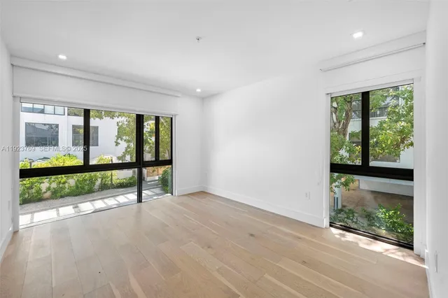 wooden floor in an empty room with glass windows