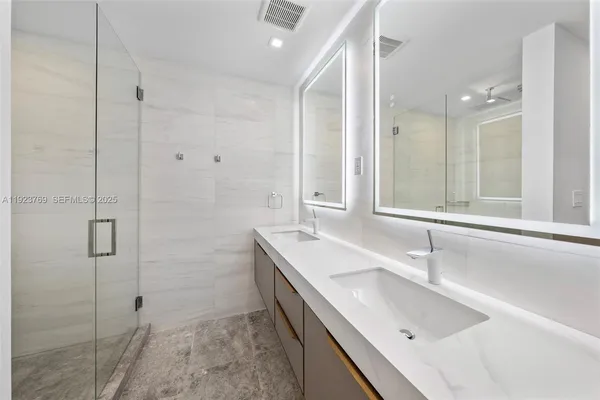 a bathroom with a tub sink shower and mirror